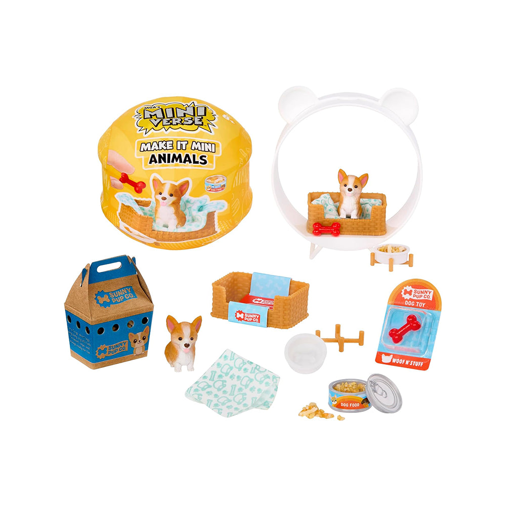 A children's pet play set arranged on a white background, including a yellow round pet house with a dog sitting in it, a white bear-shaped pet bed with a dog inside, a blue carrier bag, a small dog figurine, bowls, treats, a towel, and packaging. The round house and carrier both show the brand name 'Fuzzy Pups'.