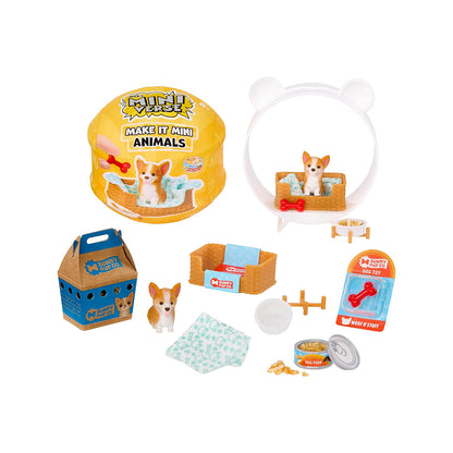 A children's pet play set arranged on a white background, including a yellow round pet house with a dog sitting in it, a white bear-shaped pet bed with a dog inside, a blue carrier bag, a small dog figurine, bowls, treats, a towel, and packaging. The round house and carrier both show the brand name 'Fuzzy Pups'.