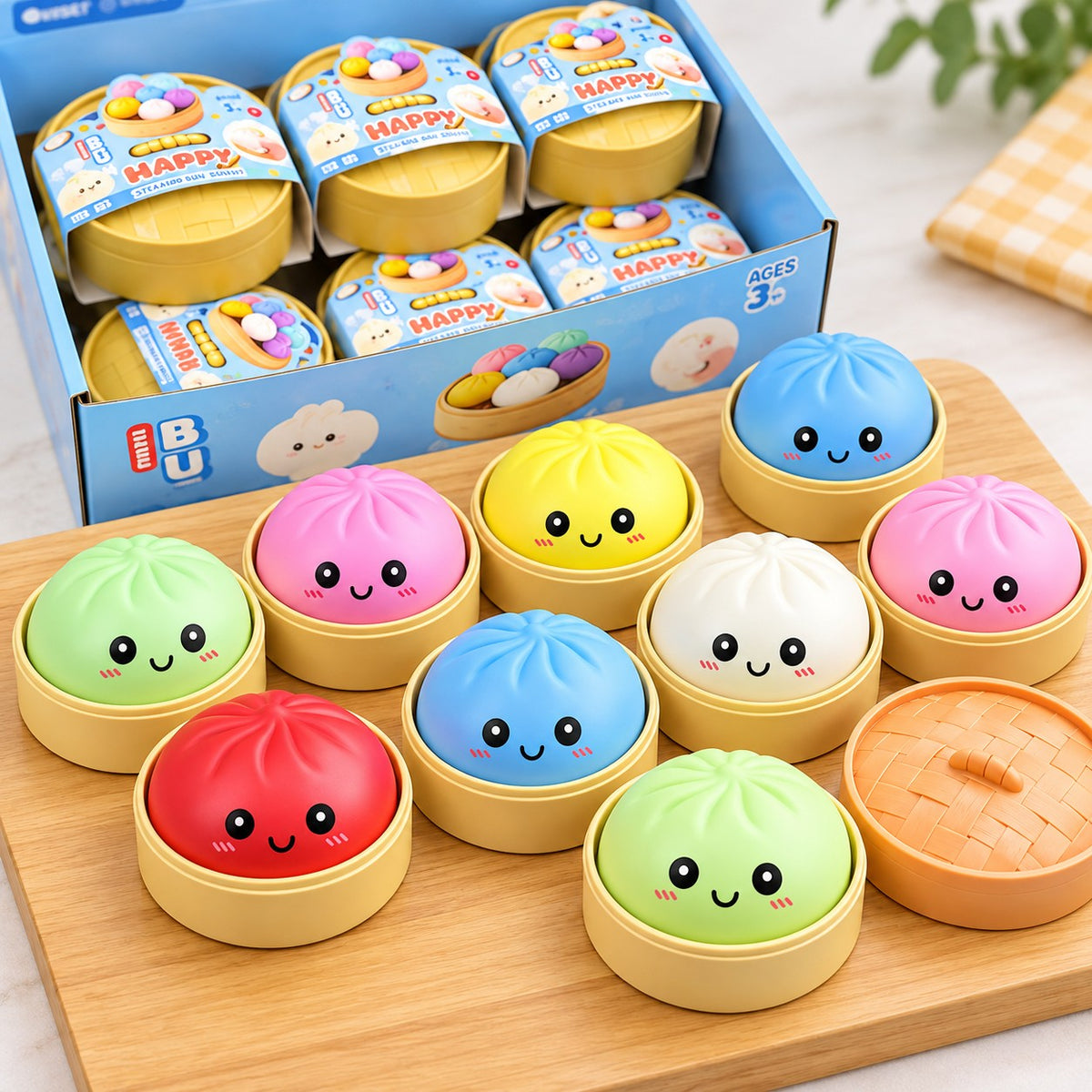 A set of cute, cartoon-style steamed bun-shaped toys in various colors (green, pink, yellow, blue, red, white, orange) sitting in bamboo basket holders on a wooden board, with a blue display box in the background.