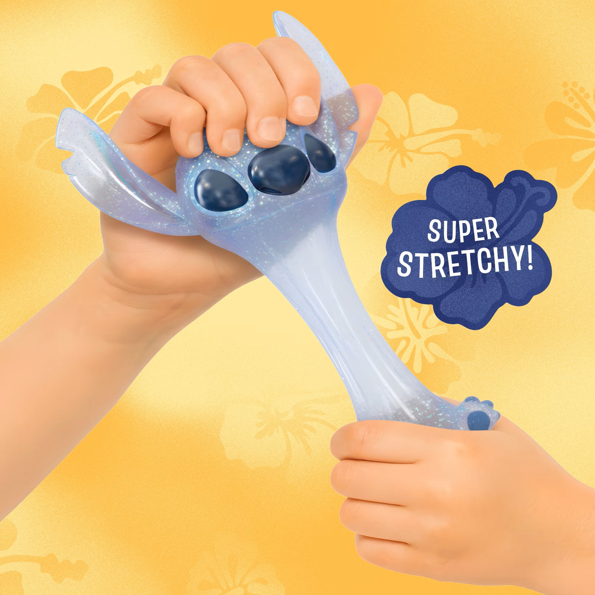 A child's hands stretch a translucent, glittery light blue character-shaped toy with dark blue paw pads, set against a warm yellow background with a 'SUPER STRETCHY!' badge.