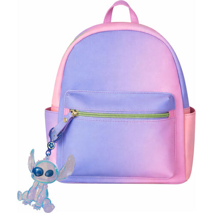 A pastel gradient backpack with a purple-to-pink color transition, featuring a front zip pocket and a small Stitch character keychain attached on the side, shown against a plain white background.
