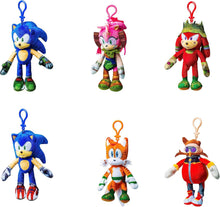 Set of six colorful plush keychains on a white background