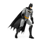 Batman action figure with black cape and gray suit on a white background