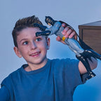 Child holding a robotic arm against a blue background