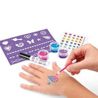 Hand painting temporary tattoos with colorful ink and a stencil on a white background